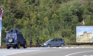 Kosovo police officers guard the road near the village of Banjska, 55 kilometers (35 miles) north of the capital Pristina, northern Kosovo, Sunday, Sept. 24, 2023. Prime Minister Albin Kurti on Sunday said one police officer was killed and another wounded in an attack he blamed on support from neighboring Serbia, increasing tensions between the two former war foes at a delicate moment in their European Union-facilitated dialogue to normalize ties. (AP Photo/Bojan Slavkovic)