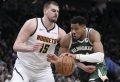 Milwaukee Bucks' Giannis Antetokounmpo tries to drive on Denver Nuggets' Nikola Jokic during the second half of an NBA basketball game Thursday, Feb. 27, 2025, in Milwaukee. (AP Photo/Morry Gash)