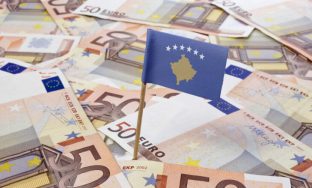 Flag of Kosovo sticking in european bank notes.